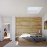 Pastel grey bedroom with a wooden siding wall featuring a skylight over the bed