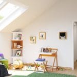 White kid’s bedroom with skylight panels on a slanted wall